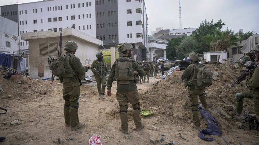 Israeli soldiers stand outside Shifa Hospital in Gaza City.