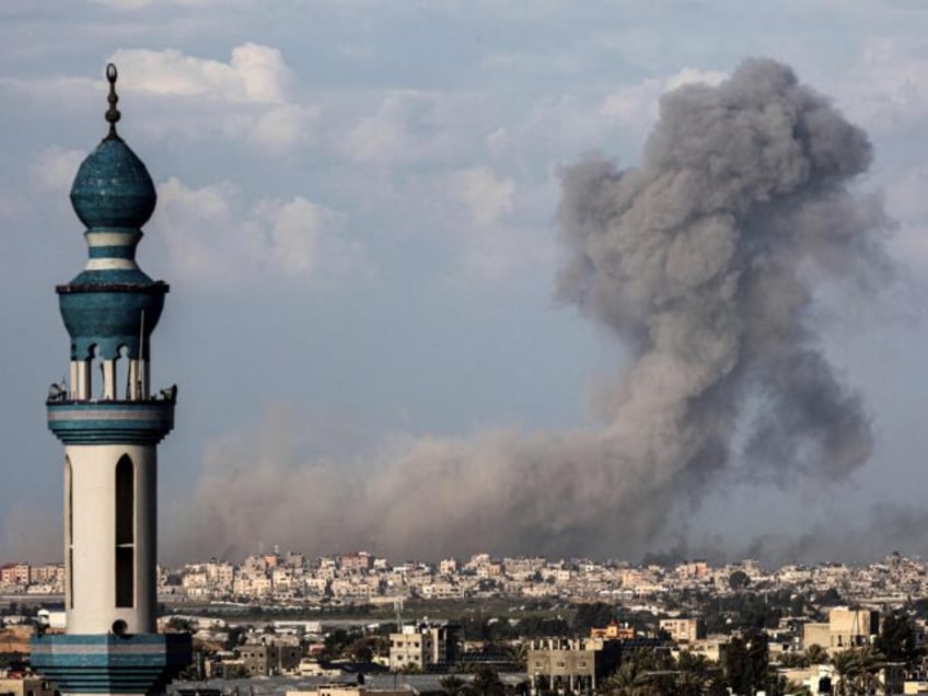 A picture taken from Rafah shows smoke billowing over Khan Yunis in the southern Gaza Stri