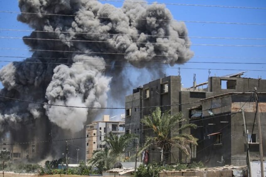 Smoke rises from a building hit by an Israeli strike in Nuseirat in the central Gaza Strip