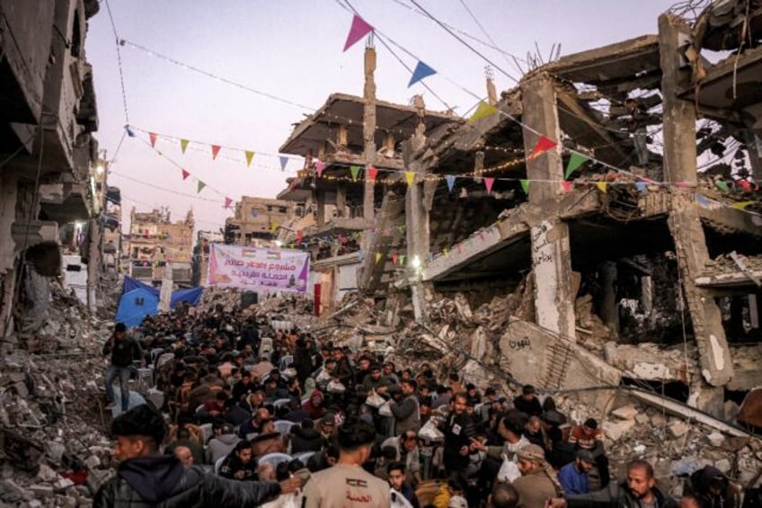 People gather for the iftar, or fast-breaking meal, on the first day of the Muslim holy fa