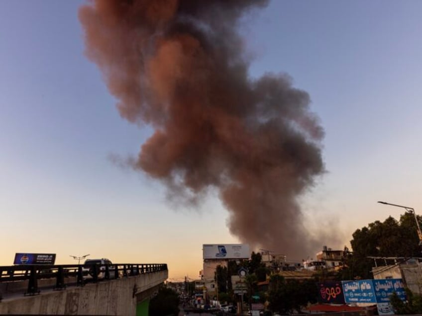 BEIRUT, LEBANON - SEPTEMBER 27: A cloud of smoke rises above the city after Israel conduct