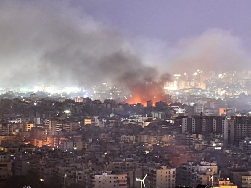 Smoke rises from the site of an Israeli airstrike that targeted a neighbourhood in a south