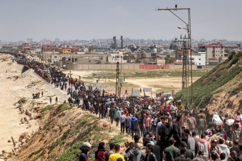 Displaced Palestinians take a coastal road through central Gaza, hoping to return to the t