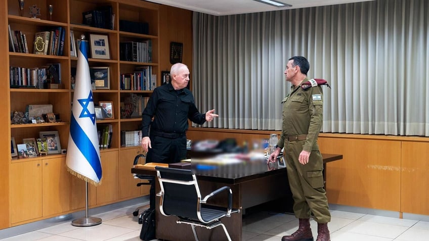 Israeli Minister of Defense Yoav Gallant, left, conducts a situation assessment. 