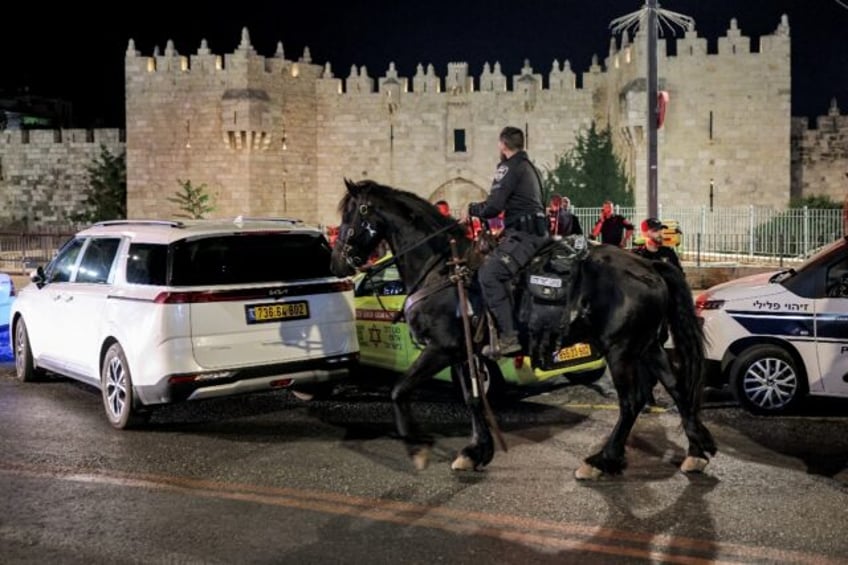 Israeli mounted police deploy near the scene of an attempted stabbing attack at the Damasc