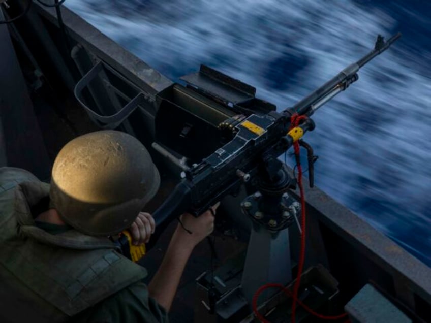 An Israeli soldier fires on board the Israeli Navy Ship Lahav during a rare tour of Israel