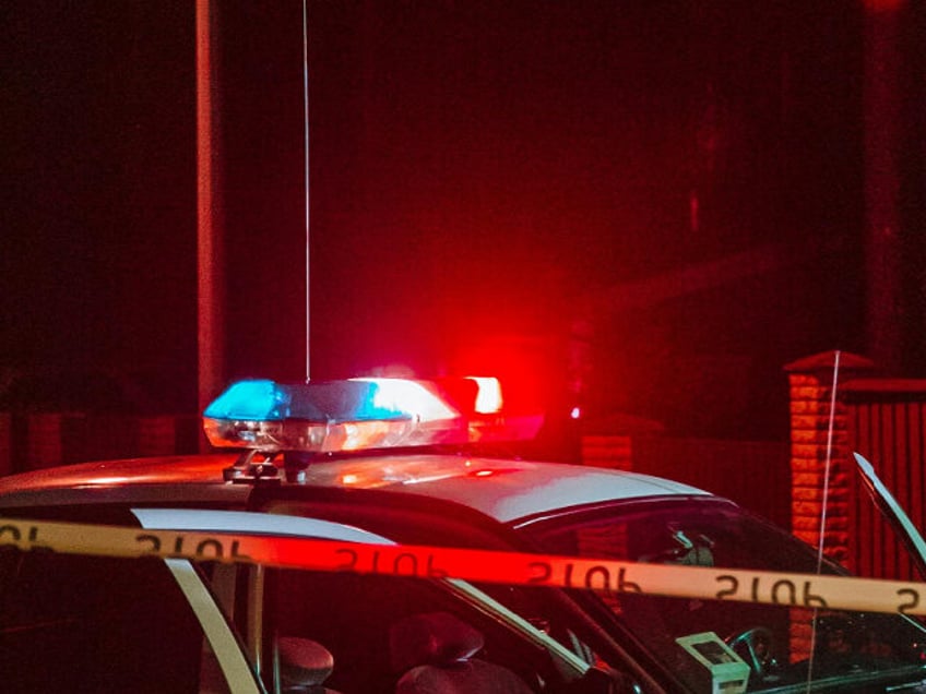 crime scene tape and police vehicle lights