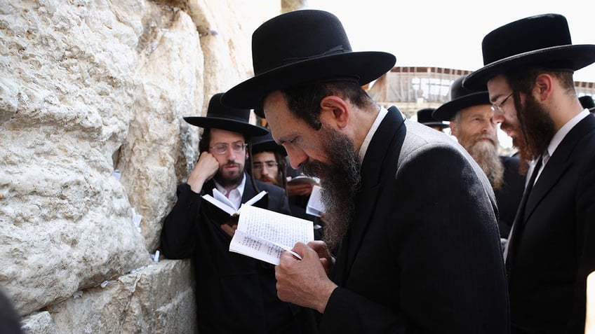 Men praying at the Western Wall.