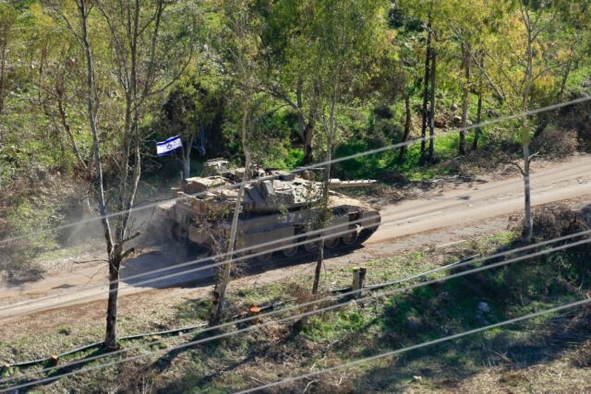 An Israeli army tank on the outskirts of the border village of Mais al-Jabal in south Leba