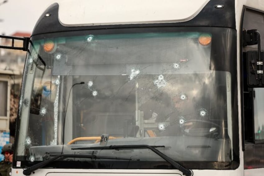 The shooting left more than a dozen bullet holes in the bus windshield