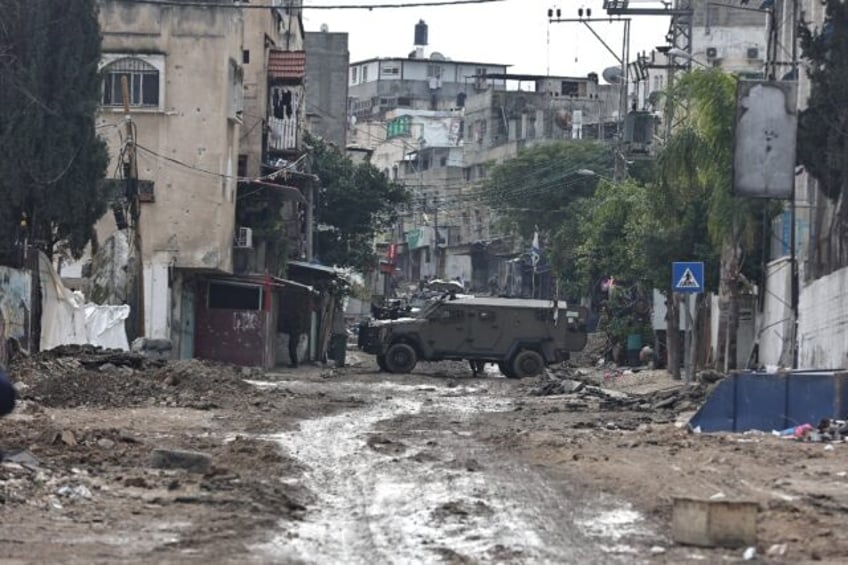 Israeli troops block off roads during a raid on Tulkarem refugee camp in the occupied West Bank