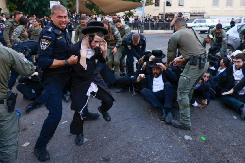 Israeli security personnel in Jerusalem disperse ultra-Orthodox Jewish protesters opposed