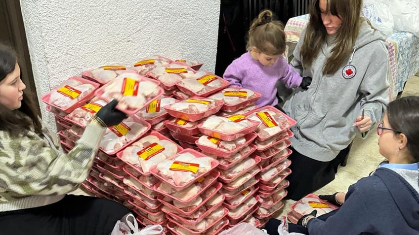 children packaging chicken for distribution