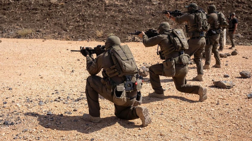 Soldiers firing weapons