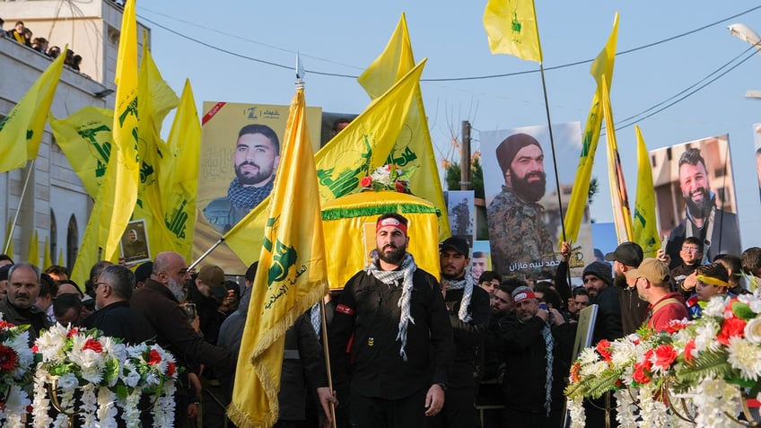 Mourners react during the funeral of Hezbollah member Hassan Ghassan Hijazi, who was killed by an Israeli strike in Tayr Debba, in southern Lebanon, January 11, 2025. 