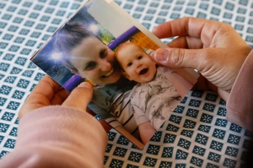 A relative of Shiri Bibas, an Israeli woman kidnaped during the October 7 attack, holds a