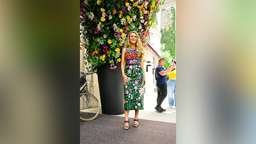 Blake Lively wore a column dress with floral designs.