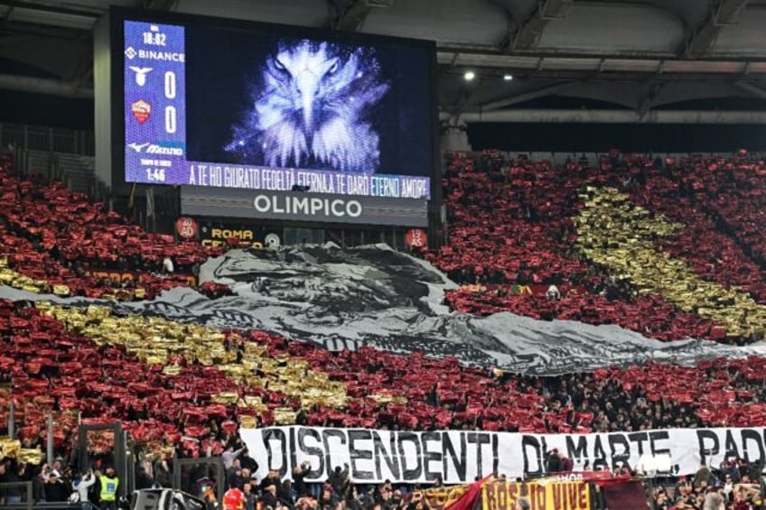 Roma fans cheer before an Italian Serie A match against city rivals Lazio last November