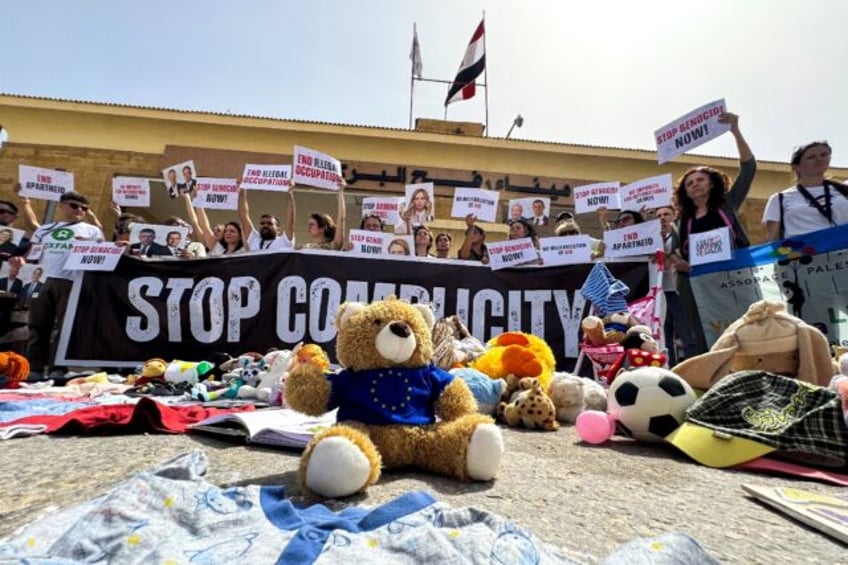 Italian parliamentarians hold placards during their protest at Egypt's side of the Rafah b