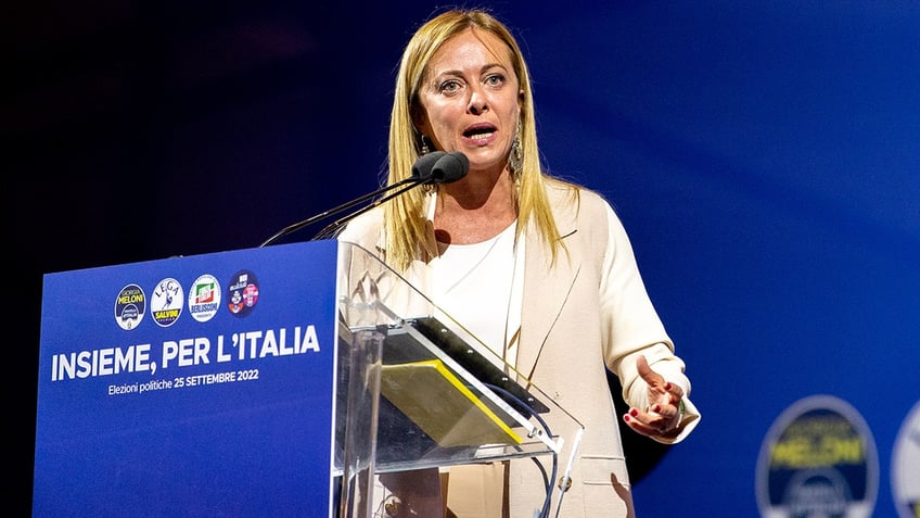 Giorgia Meloni speaks at podium during election campaign