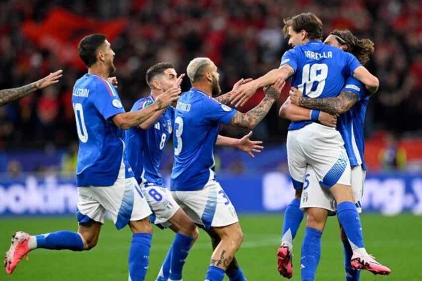 Italy players celebrate with Nicolo Barella after he scored what proved to be his side's w