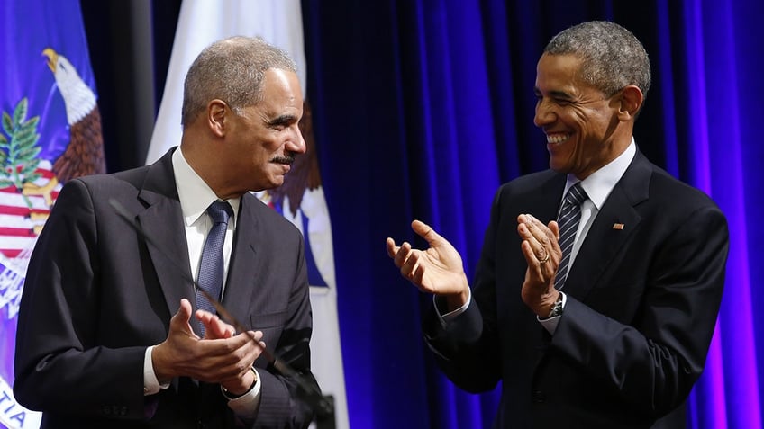 Obama and Eric Holder laugh together