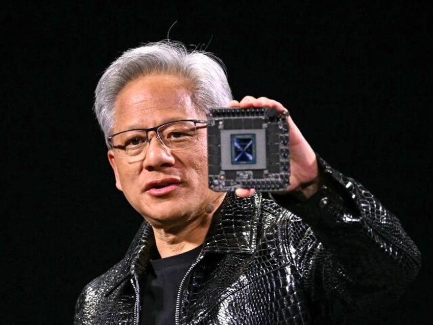 Nvidia chief Jensen Huang holding an AI chip