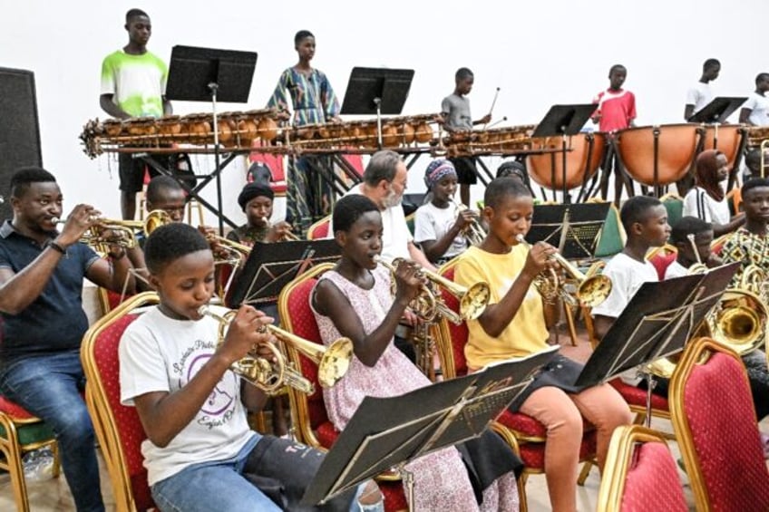 Children from a rural town in Ivory Coast have been brought together to play in a philharm