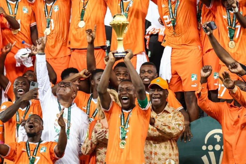 Ivory Coast's Max-Alain Gradel lifts the Africa Cup of Nations trophy aloft after Sunday's