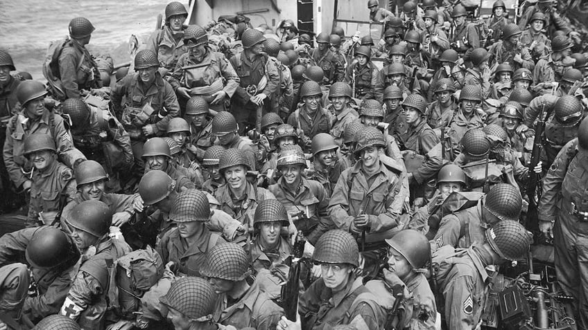 US Army troops crowd into a navy landing craft infantry ship during the D-Day Invasion of Normandy