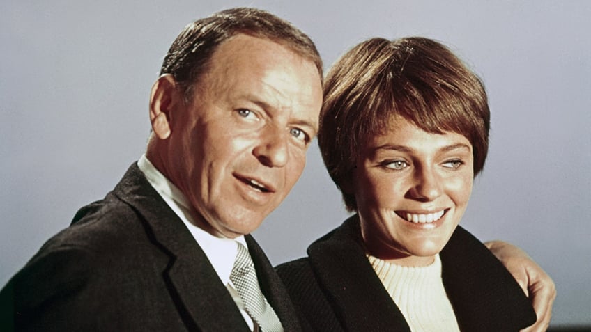 Frank Sinatra and Jacqueline Bisset pose for a photo