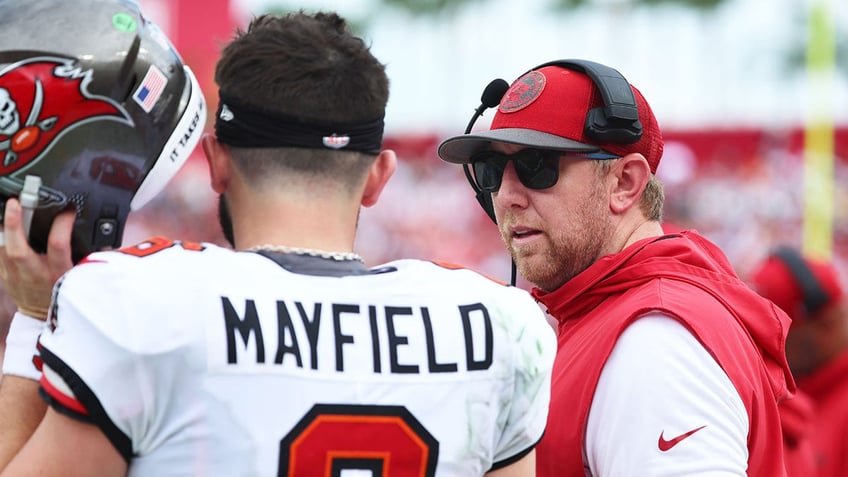 Liam Coen looks at Baker Mayfield