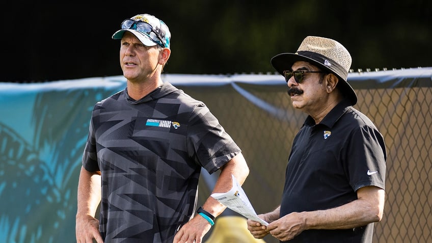Trent Baalke and Shad Khan look on during a Jacksonville Jaguars practice 