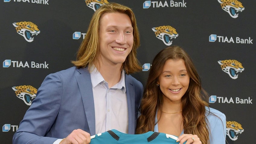 Trevor Lawrence smiles with wife