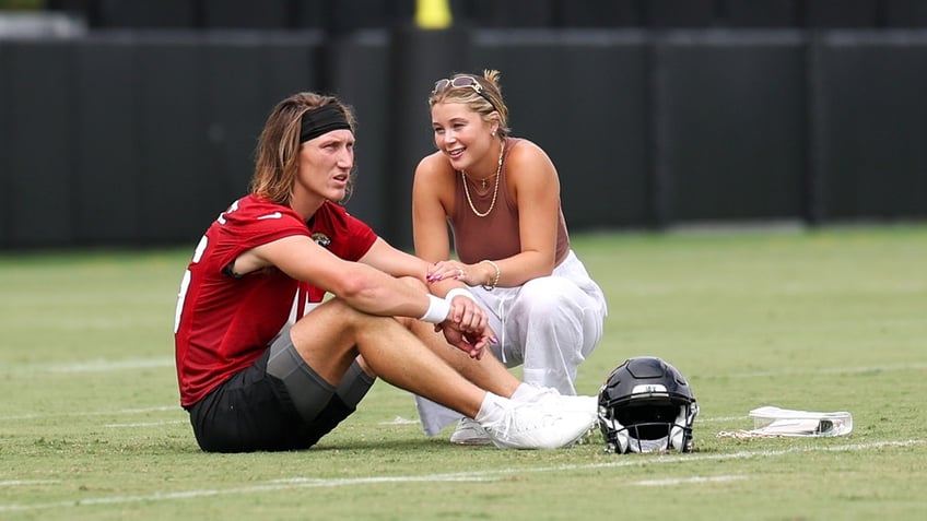 Trevor Lawrence talks with wife