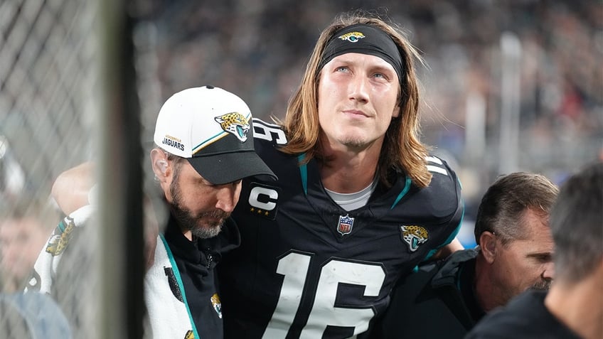 Trevor Lawrence is helped off the field