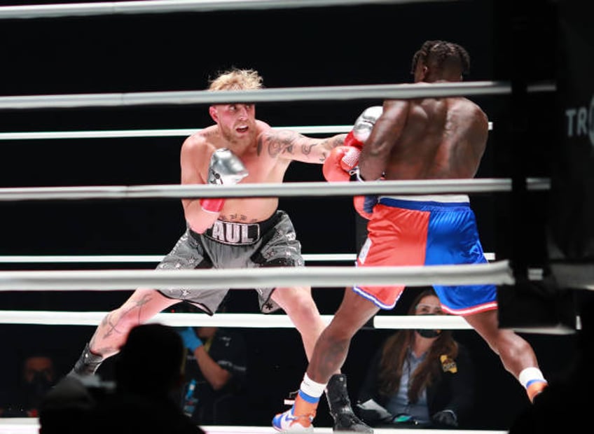 Jake Paul throws a punch against Nate Robinson in the first round during Mike Tyson vs Roy Jones Jr. Presented by Triller at Staples Center on...