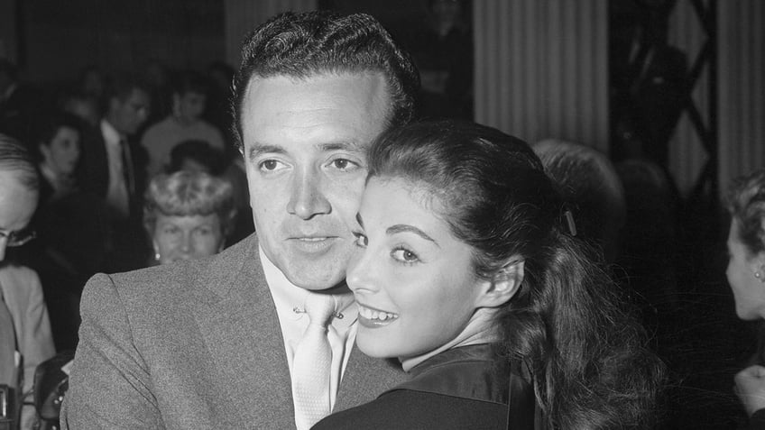 Vic Damone leaning on a smiling Pier Angeli