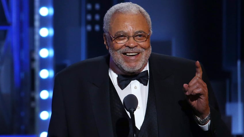 Actor James Earl Jones laugh on stage during awards show.