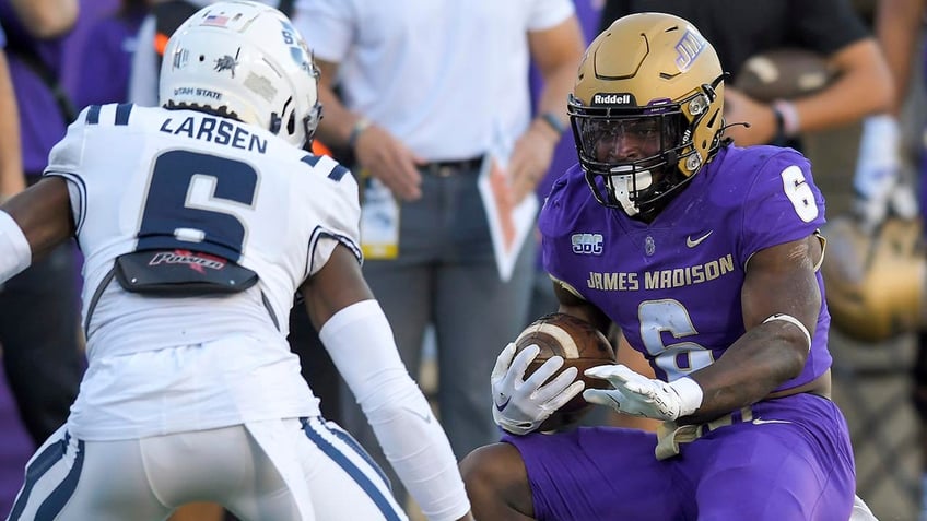 james madison football coaches pull out cellphone to get ref to overturn call