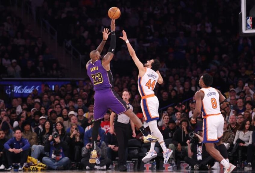 LeBron James of the Los Angeles Lakers shoots over Landry Shamet in the Lakers' NBA victor