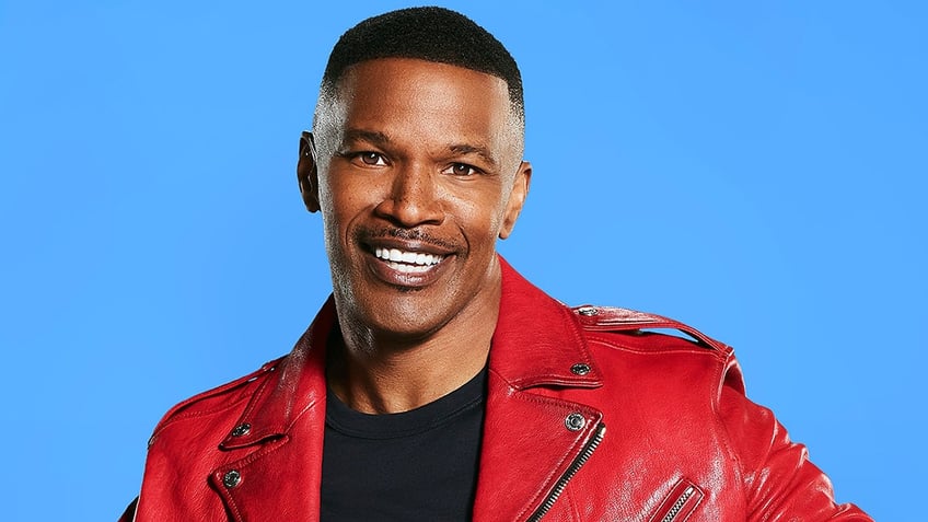 Jamie Foxx wears red leather jacket and black shirt for portrait