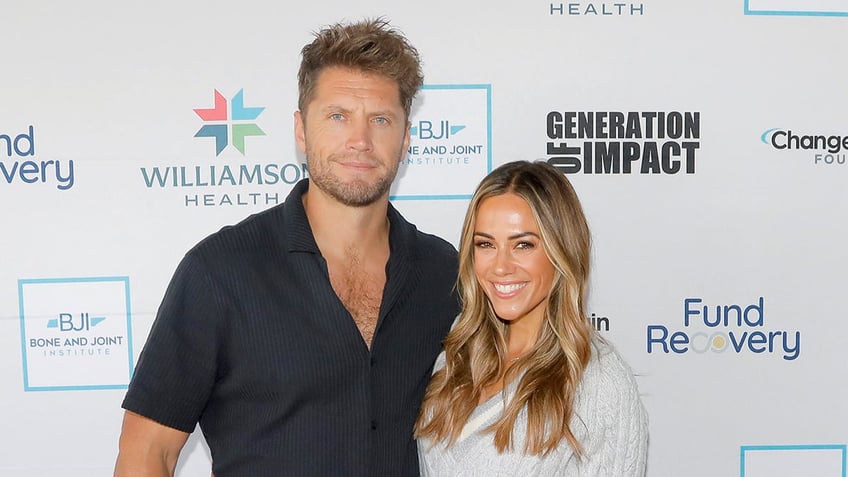 Jana Kramer sports grey sweater next to husband Allan Russell