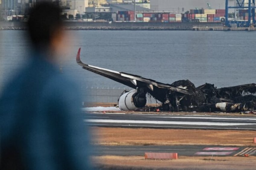 Charred remains of the planes were still littering one of Haneda's four runways