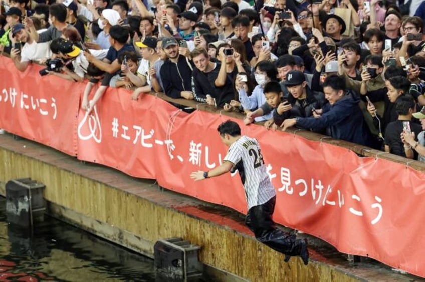 japan baseball fans leap into river as curse of the colonel lifted