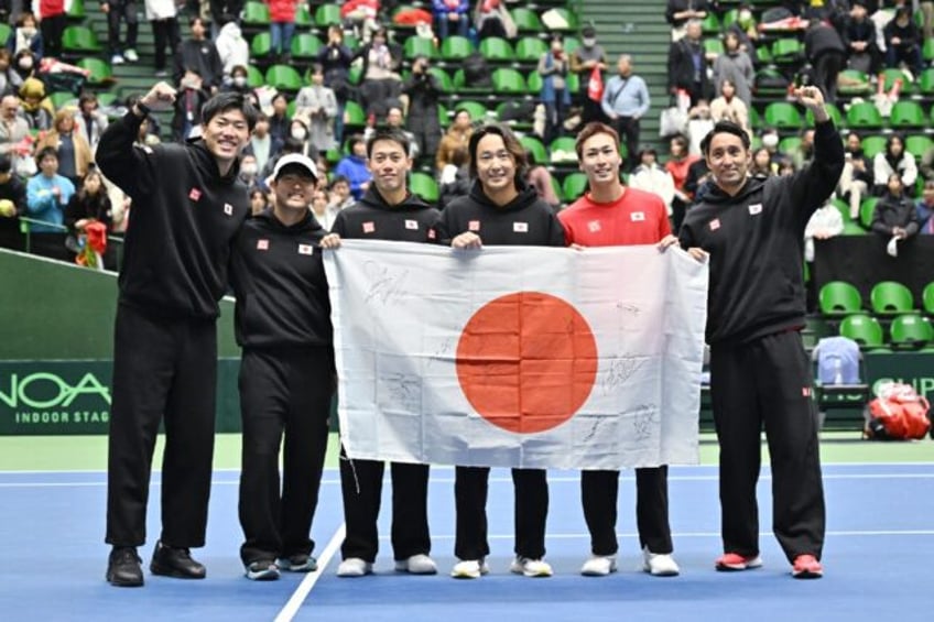 Japan celebrate their qualifying win over Britain in Miki