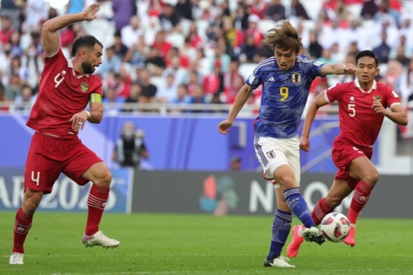 Japan beat Indonesia at the Asian Cup in Doha to move into the knockout rounds