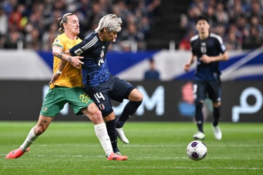 Australia's Jackson Irvine (L) and Japan's Junya Ito compete for the ball