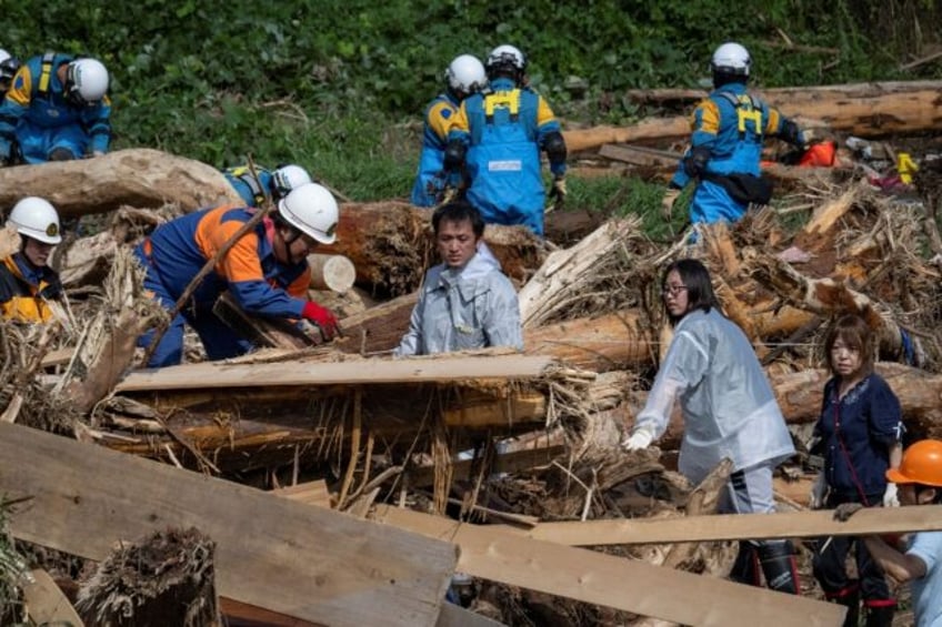 Takaya Kiso searches for his missing 14-year-old daughter Hanon after flooding washed away