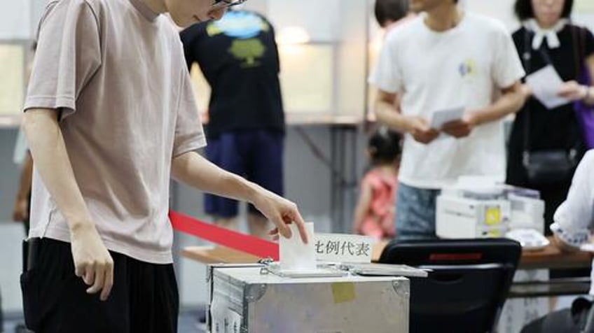japan pm ishiba vows to stay on despite ruling coalition facing major loss exit polls show